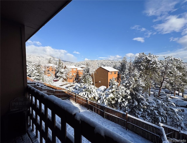 view of snow covered back of property