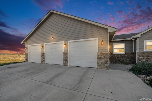 view of garage at dusk