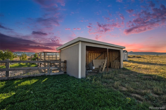 outdoor structure at dusk with a yard