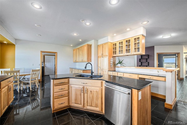 kitchen featuring light brown cabinetry, stainless steel dishwasher, kitchen peninsula, sink, and a center island