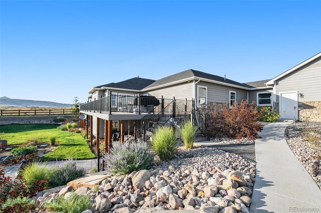 view of front of home featuring a wooden deck