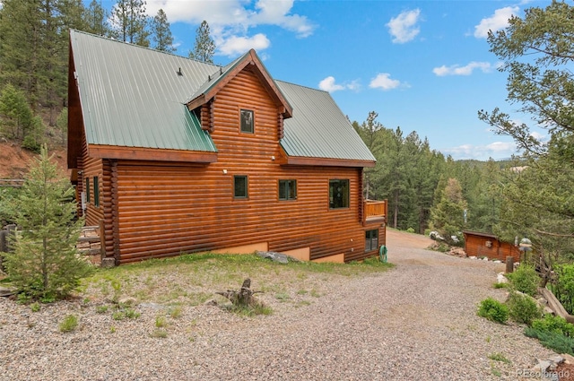 27264 Schuyler Gulch Rd, Pine, CO 80470 - view of side of home featuring log siding, metal roof, and gravel driveway
