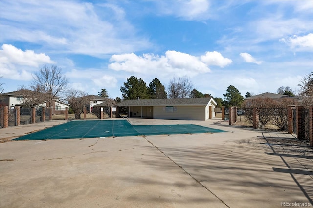 community pool featuring a patio and fence