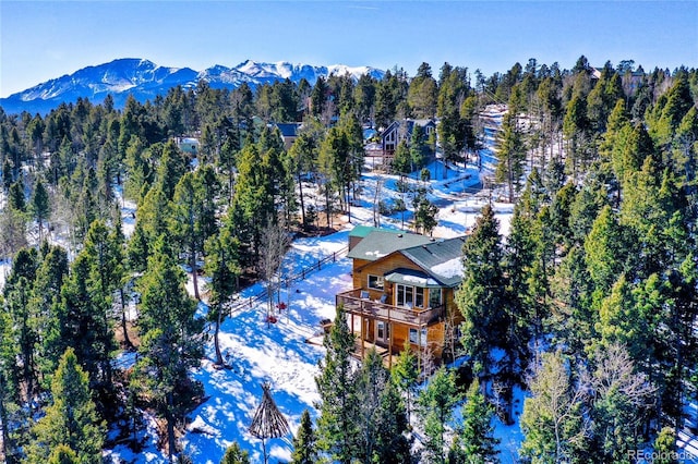 snowy aerial view with a mountain view