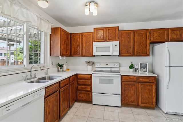 8625 W Dartmouth Pl, Lakewood, CO 80227 - kitchen featuring white appliances, a sink, light countertops, and light tile patterned floors
