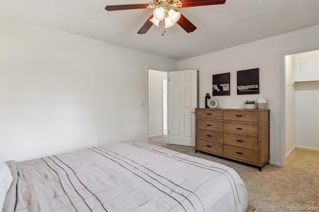 8625 W Dartmouth Pl, Lakewood, CO 80227 - bedroom with light carpet, ceiling fan, baseboards, and a textured ceiling