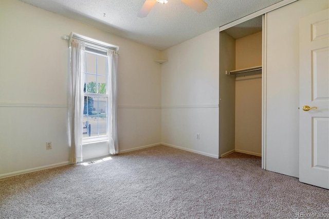 8625 W Dartmouth Pl, Lakewood, CO 80227 - unfurnished bedroom featuring carpet, a textured ceiling, a closet, a ceiling fan, and baseboards
