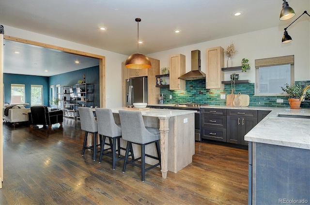 656 S Gunnison Ave, Buena Vista, CO 81211 - kitchen with a sink, wall chimney range hood, dark wood-type flooring, and appliances with stainless steel finishes