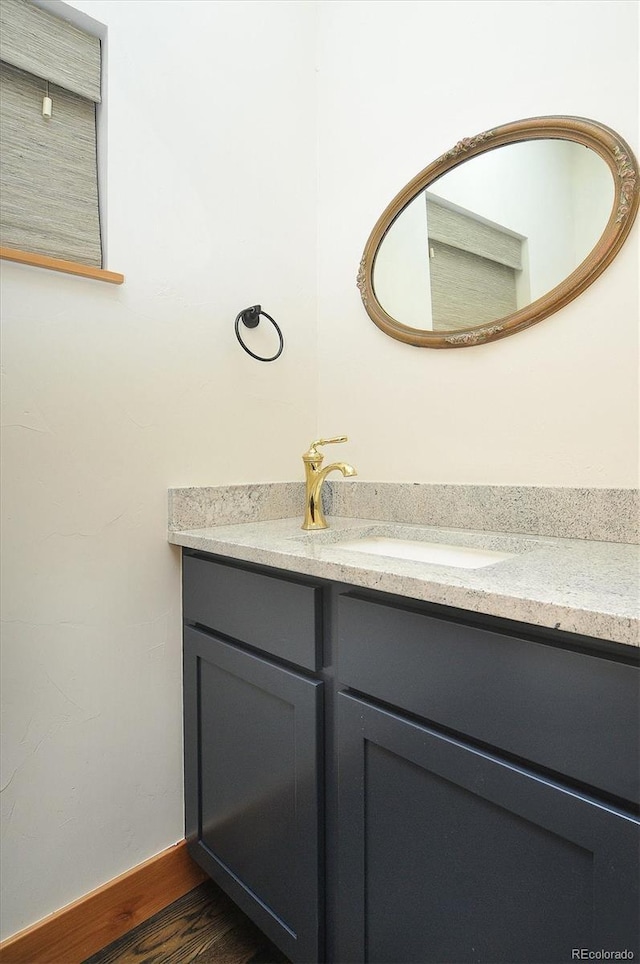 656 S Gunnison Ave, Buena Vista, CO 81211 - bathroom featuring baseboards, vanity, and wood finished floors