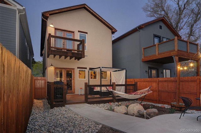 656 S Gunnison Ave, Buena Vista, CO 81211 - rear view of house with stucco siding, a fenced backyard, and a balcony