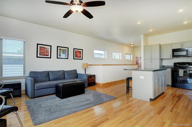 656 S Gunnison Ave, Buena Vista, CO 81211 - living room with ceiling fan, baseboards, plenty of natural light, and light wood-style floors