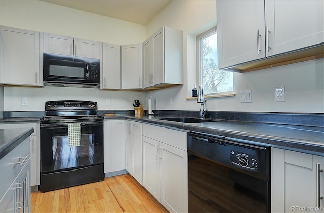 656 S Gunnison Ave, Buena Vista, CO 81211 - kitchen with black appliances, a sink, dark countertops, and light wood finished floors