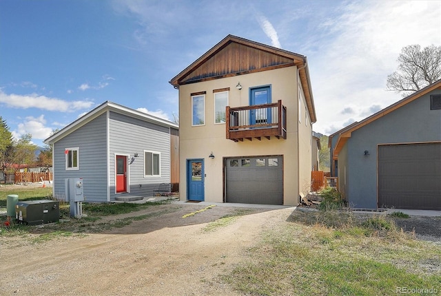 656 S Gunnison Ave, Buena Vista, CO 81211 - view of front of home featuring a balcony, driveway, stucco siding, and a garage