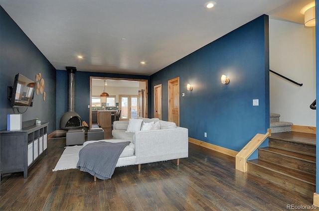 656 S Gunnison Ave, Buena Vista, CO 81211 - living area with stairway, baseboards, dark wood-type flooring, a wood stove, and recessed lighting