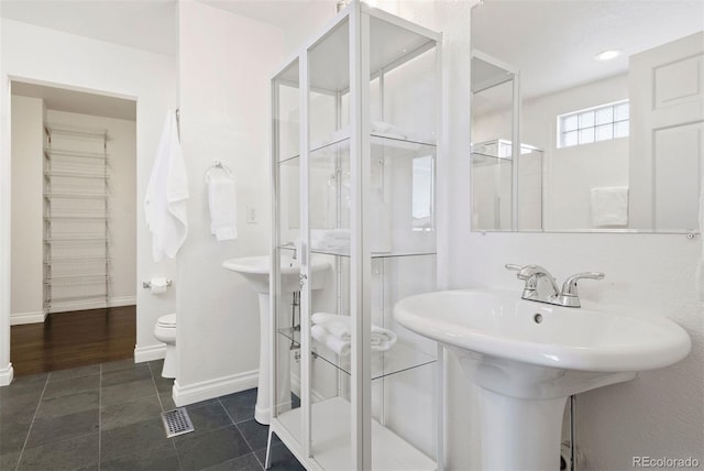 bathroom with tile patterned floors, sink, and toilet