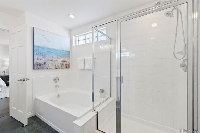 bathroom with shower with separate bathtub and tile patterned floors