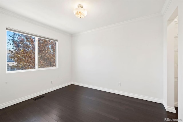 empty room with crown molding and dark wood-type flooring