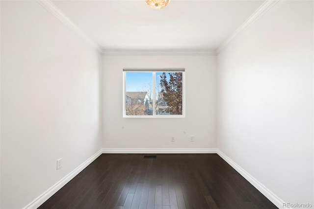 spare room featuring dark wood-type flooring and ornamental molding