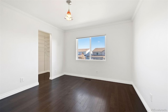 spare room with dark hardwood / wood-style floors and ornamental molding