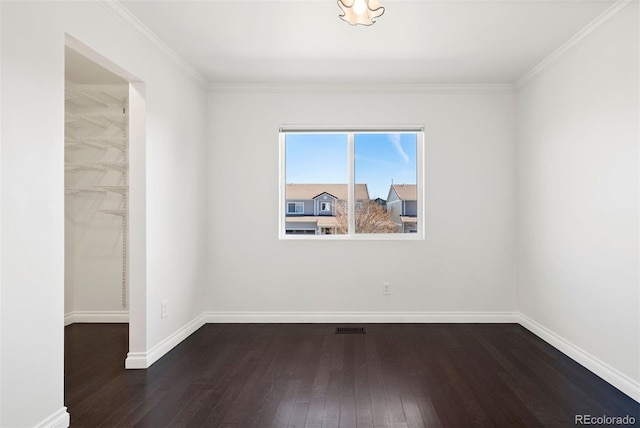 unfurnished room with dark hardwood / wood-style flooring and crown molding