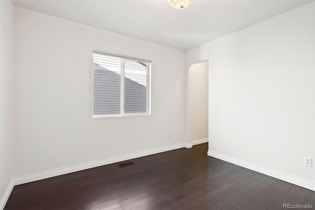 unfurnished room featuring dark wood-type flooring