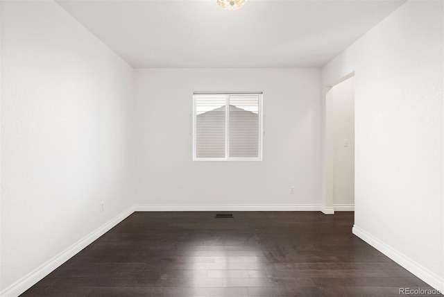 spare room featuring dark hardwood / wood-style floors