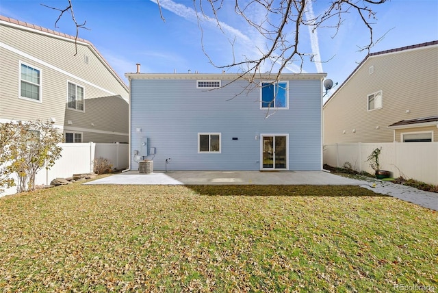 rear view of property featuring a yard and a patio