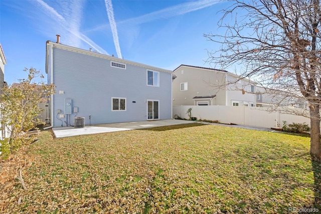 rear view of house featuring a lawn, a patio, and central AC unit