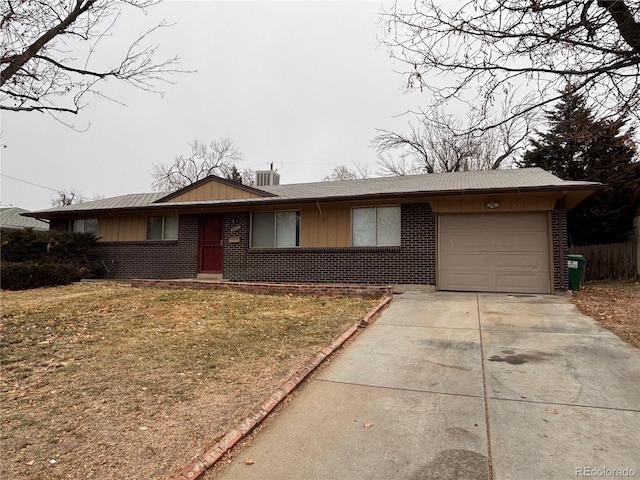 ranch-style house with a garage and a front yard