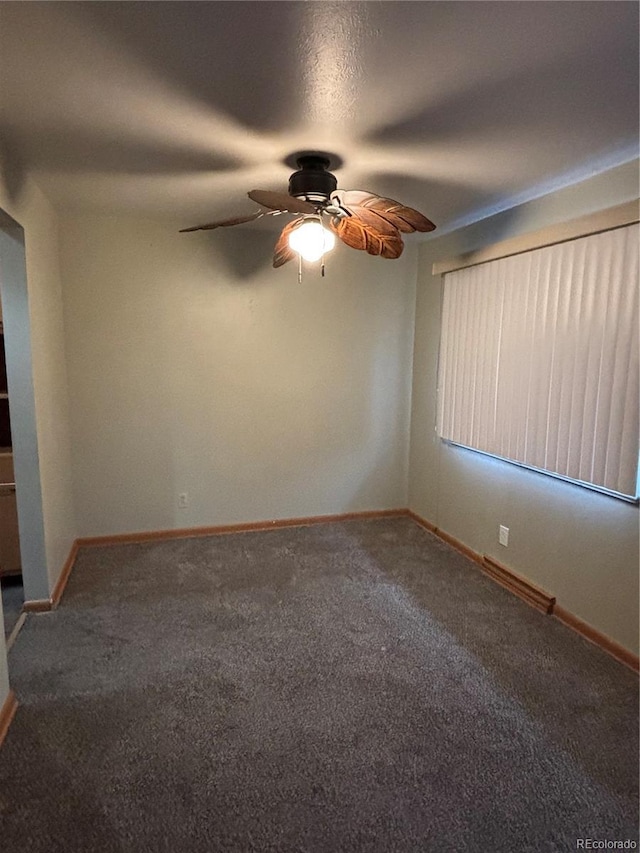 spare room featuring carpet and ceiling fan