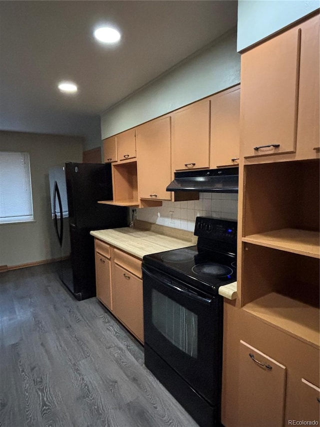 kitchen featuring black appliances, light hardwood / wood-style floors, and tasteful backsplash