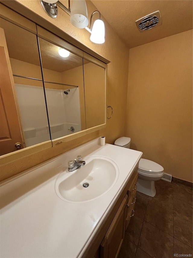 bathroom with walk in shower, tile patterned floors, a textured ceiling, toilet, and vanity