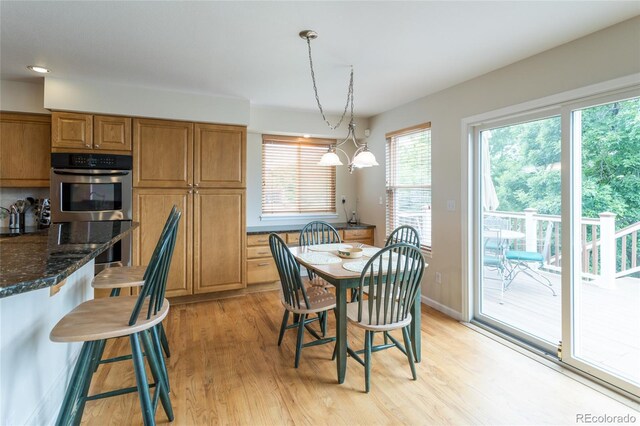 14261 W Evans Cir, Lakewood, CO 80228 - dining room with light wood-style floors and baseboards