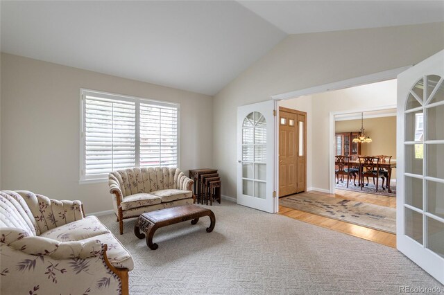 14261 W Evans Cir, Lakewood, CO 80228 - sitting room featuring a chandelier, vaulted ceiling, and wood finished floors