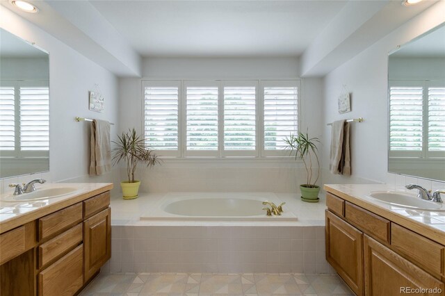 14261 W Evans Cir, Lakewood, CO 80228 - full bath featuring two vanities, plenty of natural light, and a garden tub