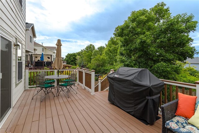 14261 W Evans Cir, Lakewood, CO 80228 - wooden terrace featuring outdoor dining space and grilling area