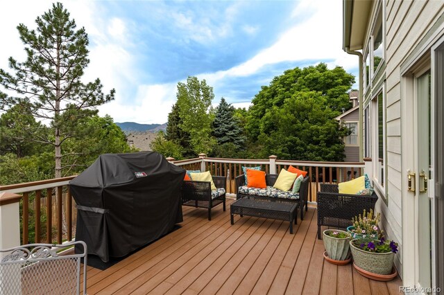 14261 W Evans Cir, Lakewood, CO 80228 - wooden terrace featuring an outdoor hangout area, a grill, and a mountain view