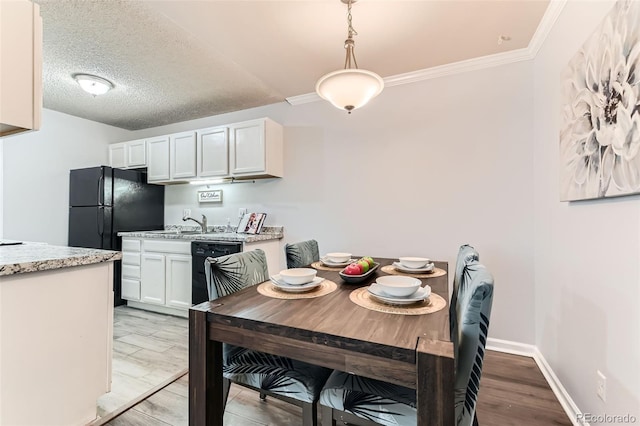 10211 Ura Ln Unit 1-308, Thornton, CO 80260 - dining space with light wood-style flooring and ornamental molding