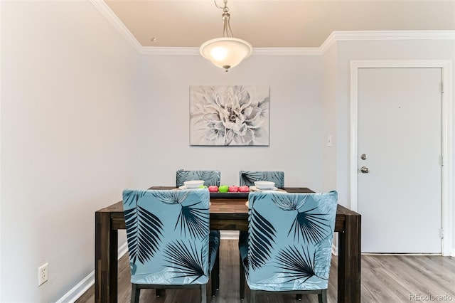 10211 Ura Ln Unit 1-308, Thornton, CO 80260 - dining area featuring wood finished floors and ornamental molding