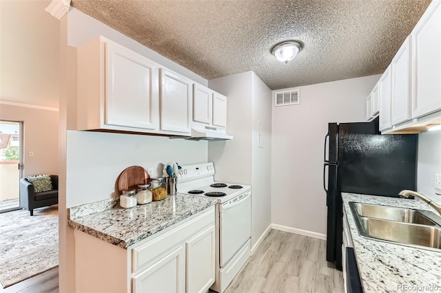 10211 Ura Ln Unit 1-308, Thornton, CO 80260 - kitchen with white range with electric stovetop, light wood-type flooring, under cabinet range hood, white cabinetry, and a textured ceiling