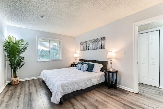 10211 Ura Ln Unit 1-308, Thornton, CO 80260 - bedroom with wood finished floors and a textured ceiling