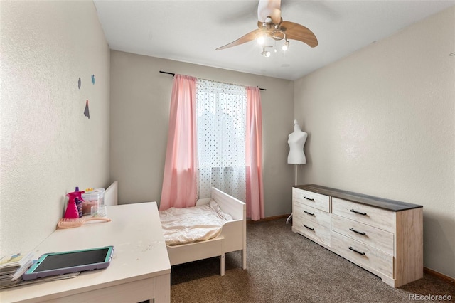 bedroom with carpet flooring, ceiling fan, and a textured wall