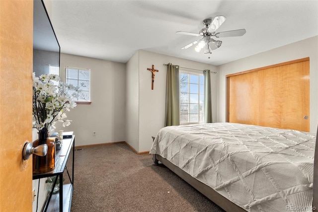 carpeted bedroom with a ceiling fan and baseboards