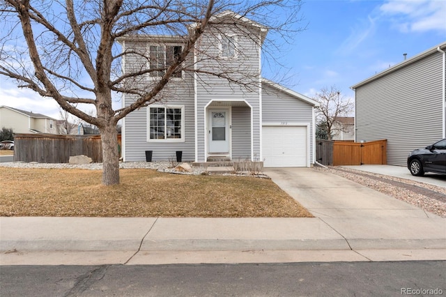 traditional-style home with concrete driveway, a garage, and fence