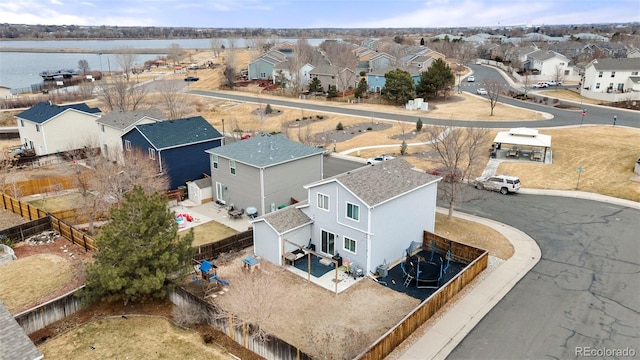 drone / aerial view featuring a residential view and a water view