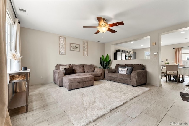 living room with visible vents and ceiling fan