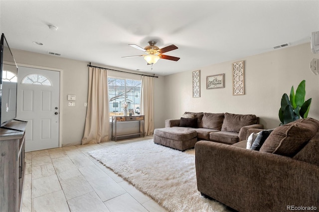 living room with visible vents and ceiling fan