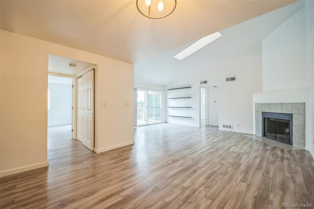 10303 E Peakview Ave Unit G203, Englewood, CO 80111 - unfurnished living room with baseboards, light wood-style floors, a fireplace, and visible vents