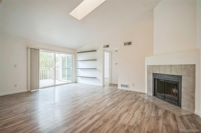 10303 E Peakview Ave Unit G203, Englewood, CO 80111 - unfurnished living room featuring wood finished floors, visible vents, and high vaulted ceiling