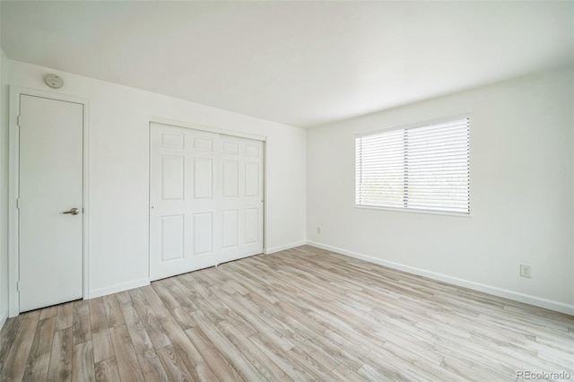 10303 E Peakview Ave Unit G203, Englewood, CO 80111 - unfurnished bedroom with light wood finished floors, a closet, and baseboards